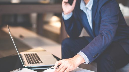 Handsome businessman in suit and eyeglasses speaking phone in office,Side view shot of man hands using smart phone business man busy using cell phone at office, Smart asian Business Professional; Shutterstock ID 611424542; Department: -