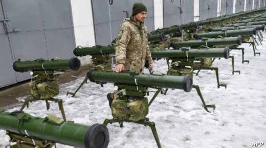 A Ukrainian serviceman taking part in the armed conflict with Russia-backed separatists in the country's Donetsk region poses for photos by a missile system during the handover ceremony of military heavy weapons and equipment in Kiev on November 15, 2018. - The companies of the state concern Ukroboronprom gave to the Ukrainian army more than 65 units of tanks t-72 APC BTR-3E1U, armored cars "Novator" and the 50 units of the newest Ukraine disigned highly accurate anti-tank missile systems Sugna-? and Corsair. (Photo by Sergei SUPINSKY / AFP)