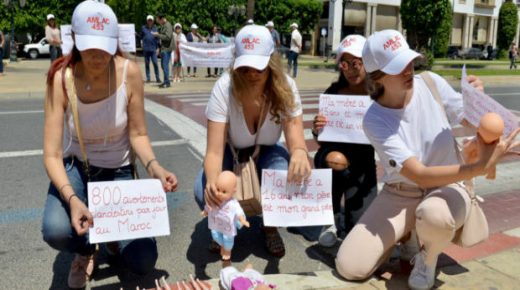 Demonstrators hold placards in front of dolls bearing the inscription "Article 453", near the parliament of the Moroccan capital Rabat on June 25, 2019, to protest against an abortion law. - "Article 453", refers to a law which punishes the voluntary termination of pregnancy (abortion) with six months to five years of imprisonment except when the health of the mother is in danger.Protesters today led an action to demand the easing of a law they believe encourages clandestine abortions and child abandonment. (Photo by - / AFP)