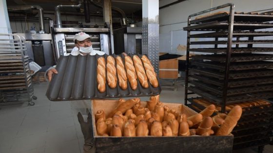 A worker arranger bread in a basket at a bakery in the El Menzah area of Tunis on February 27, 2022. - Russia's invasion of Ukraine could mean less bread on the table in Egypt, Lebanon, Yemen and elsewhere in the Arab world where millions already struggle to survive. Tunisia relies on Ukrainian and Russian imports for 60 percent of its total wheat consumption, according to agriculture ministry expert Abdelhalim Gasmi. He said current stocks are sufficient until June. (Photo by FETHI BELAID / AFP) (Photo by FETHI BELAID/AFP via Getty Images)